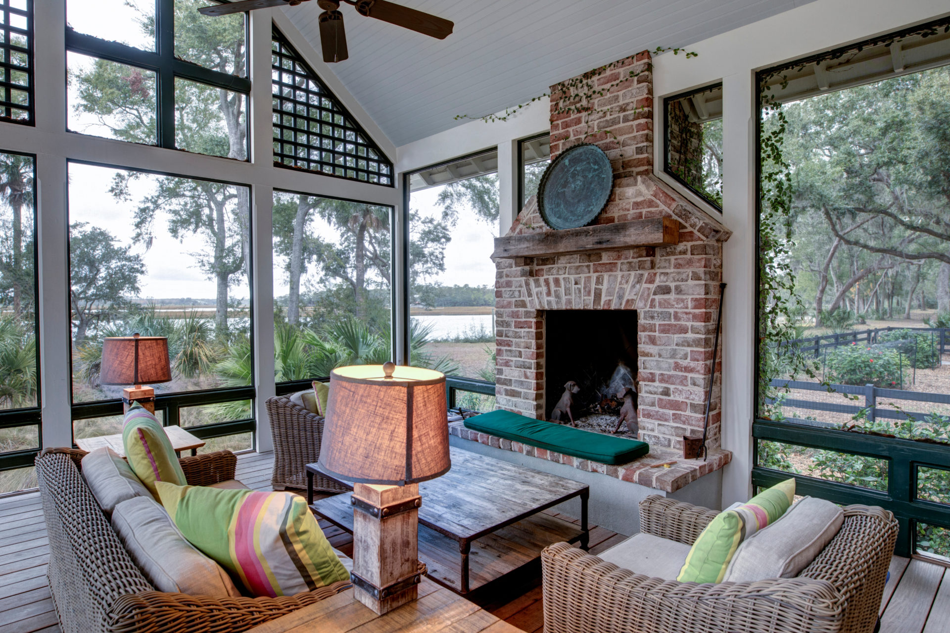 Luxurious three season screen porch with fireplace, looking out